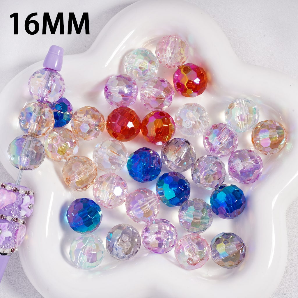 Assorted colored beads on a white heart-shaped dish with '16MM' text.