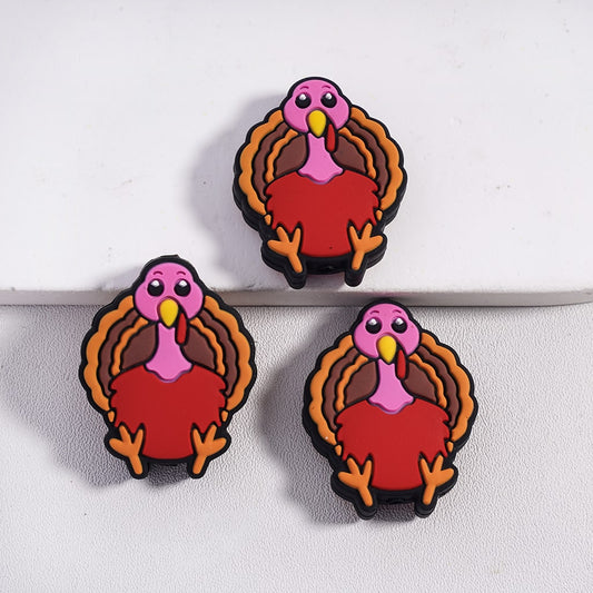 Three cartoon-style turkey magnets on a white surface