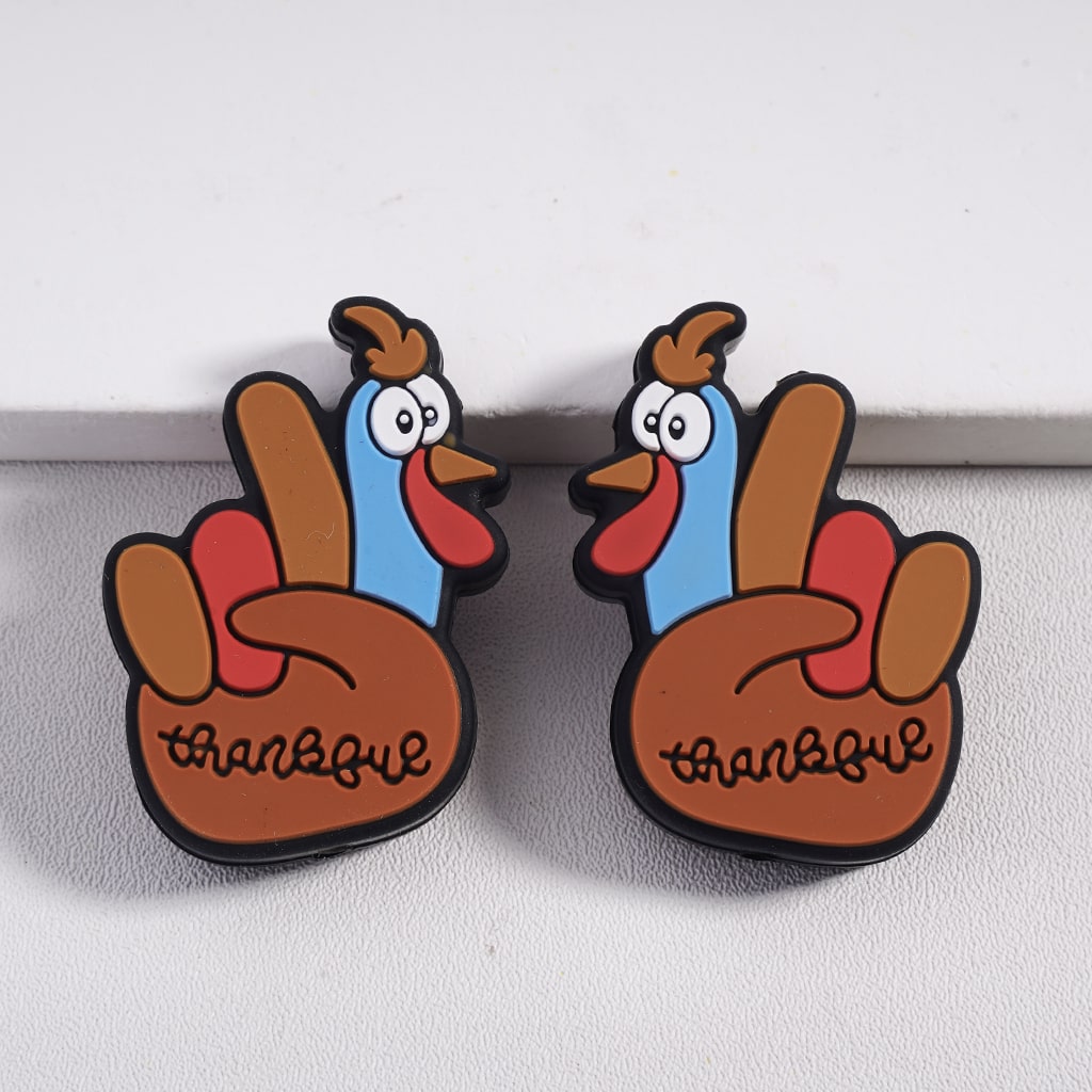 Two cartoon-style turkey magnets with 'thankful' text on a white surface.