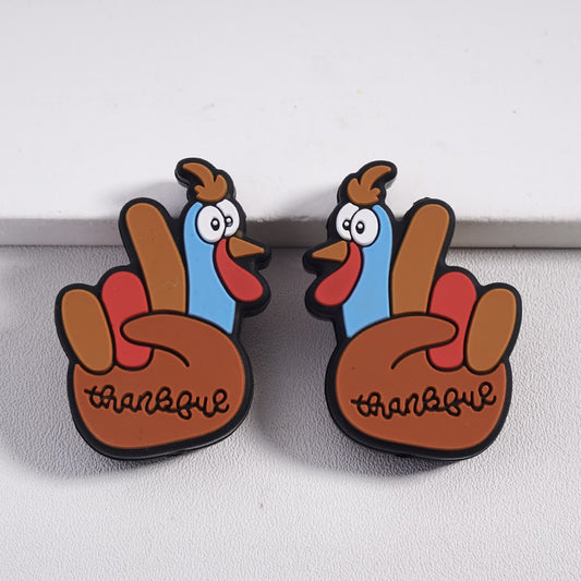 Two cartoon-style turkey magnets with 'thankful' text on a white surface.