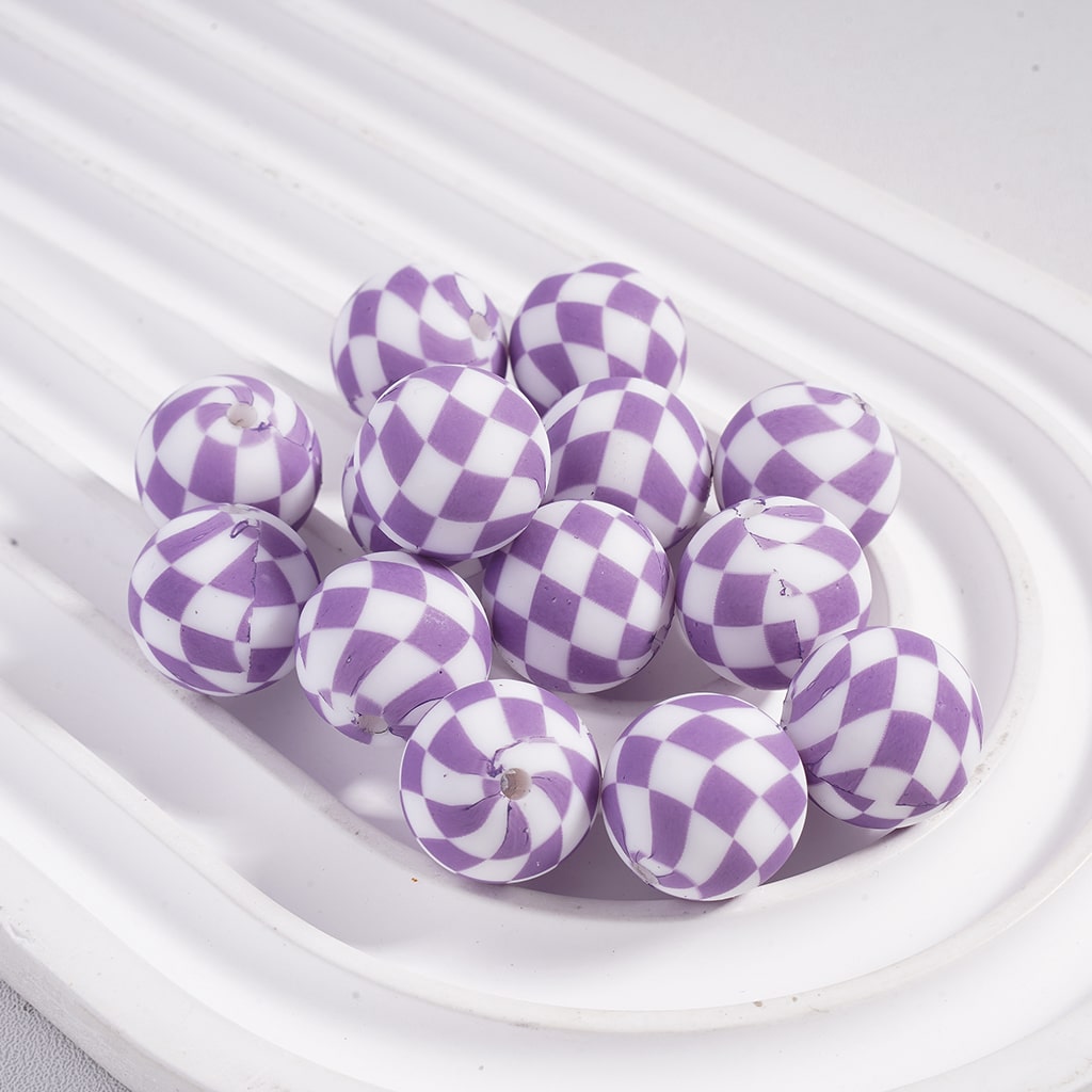 Purple and white checkered beads on a white plate