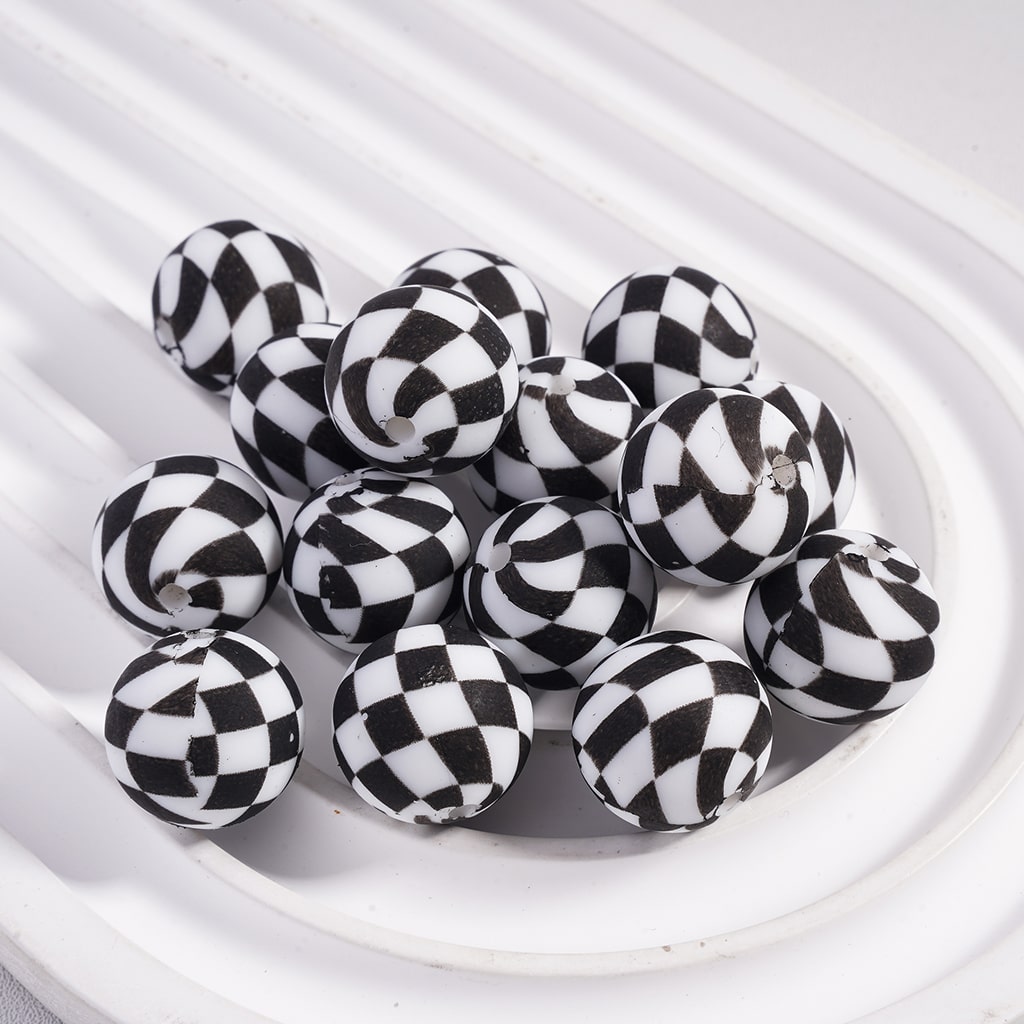 Black and white checkered beads on a white plate