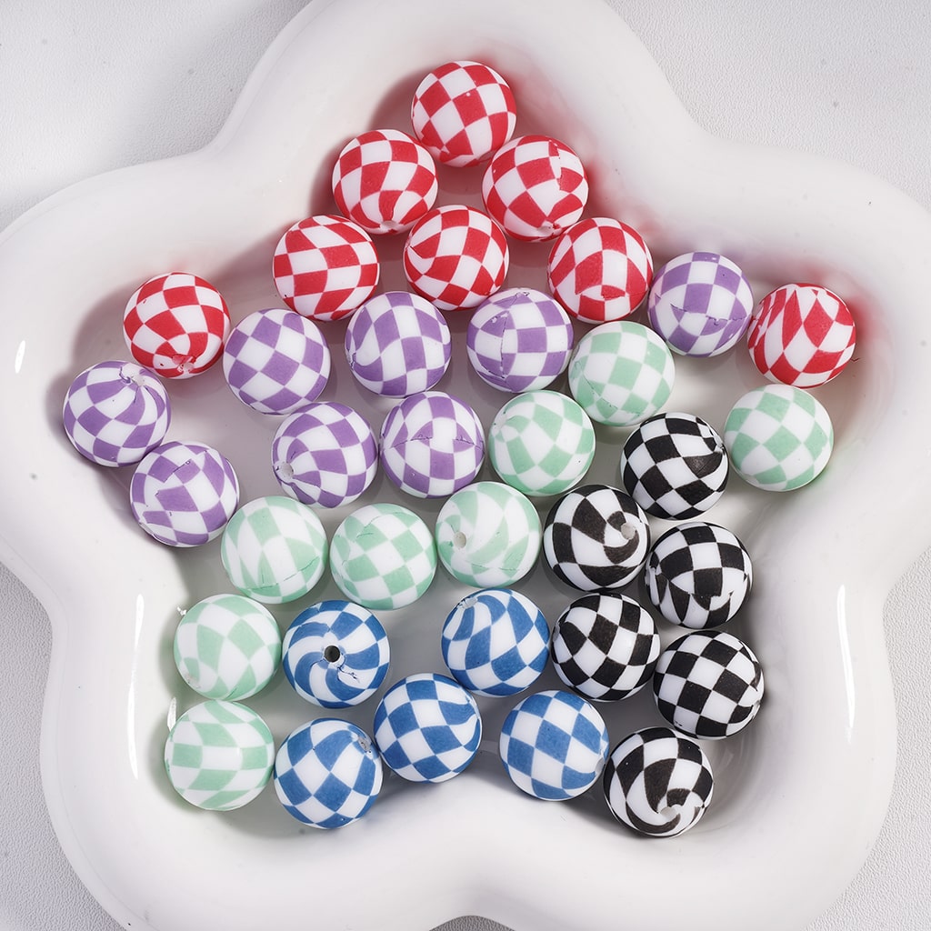 Colorful checkered beads in a white dish
