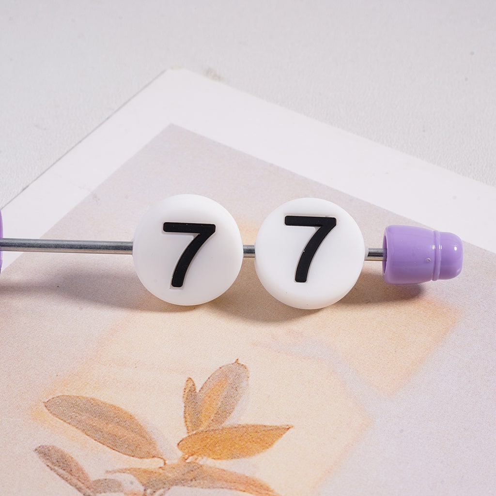 Bobby pin with number '7' on a white background