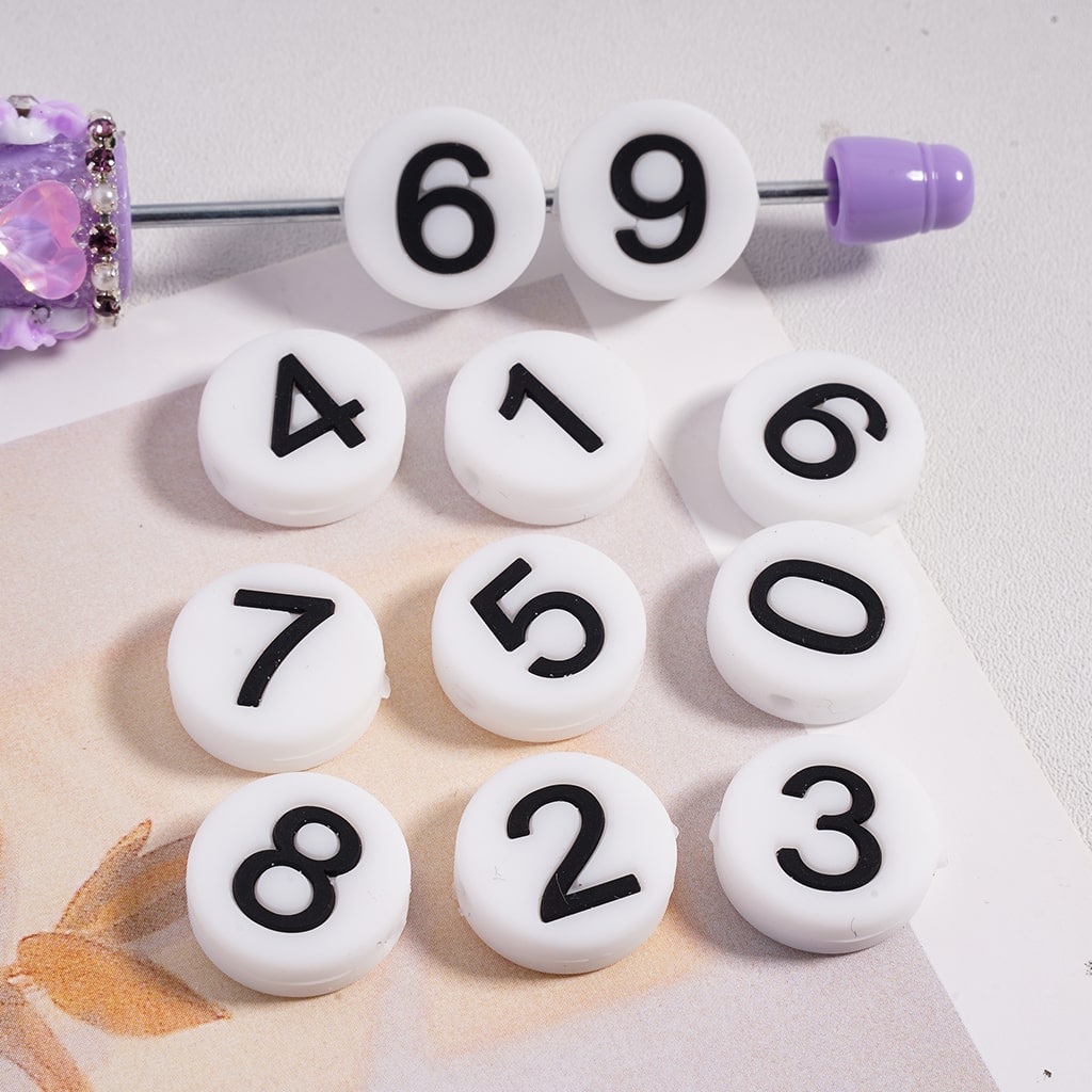 White beads with black numbers on a white background
