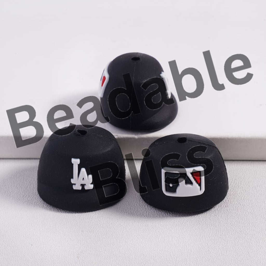 Black silicone beads with logos on a white background, featuring 'Beadable Bliss' branding.