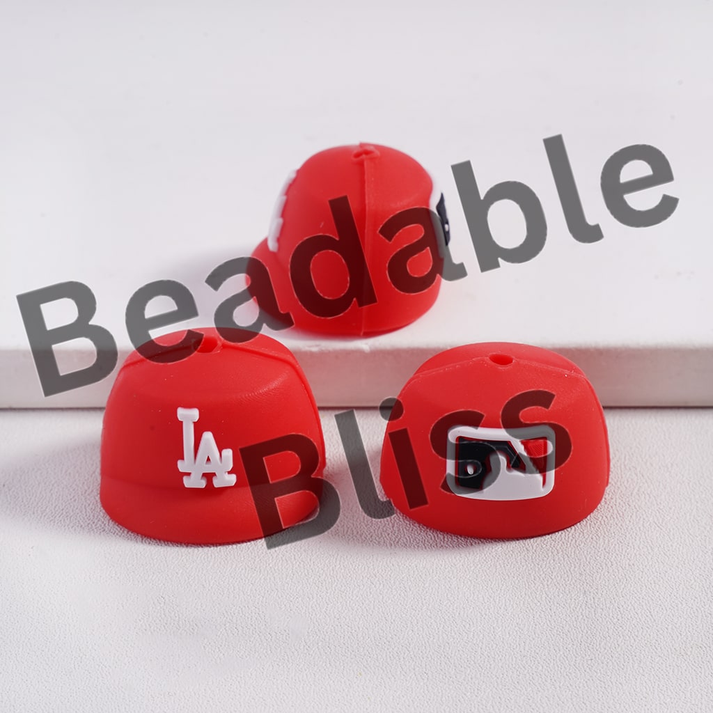 Red silicone beads with a logo on a white background, branded 'Beadable Bliss'.