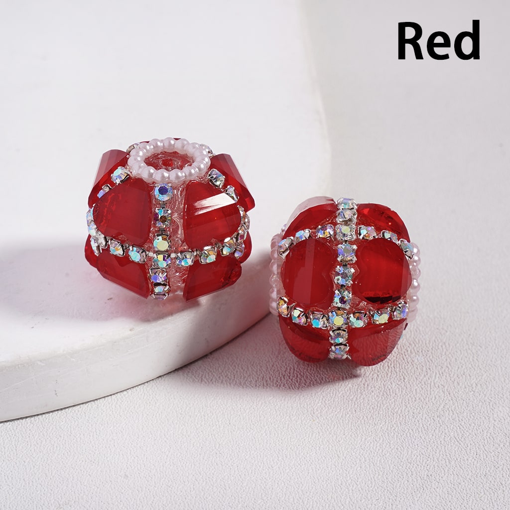 Red earrings with gemstone accents on a white background
