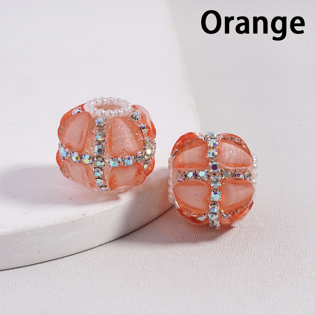 Orange beaded earrings with gemstones on a light background