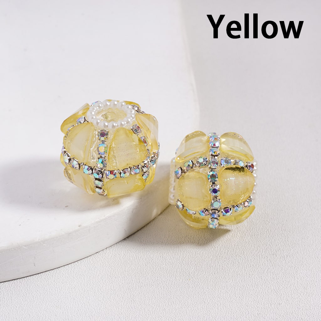 Yellow earrings with gemstone accents on a white background