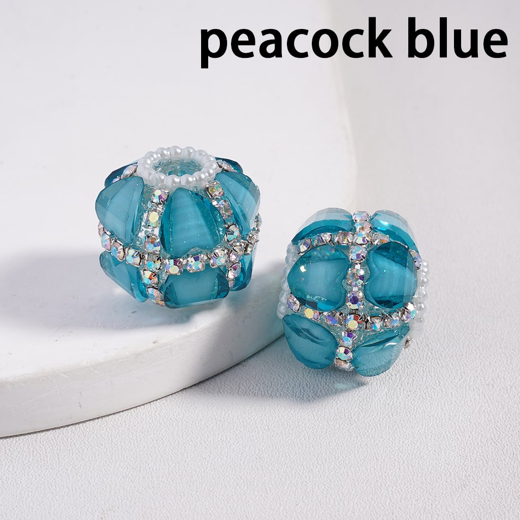 Pair of blue earrings with gemstone accents on a light gray background