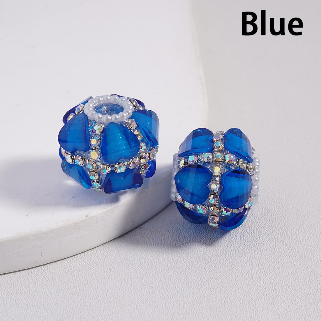 Blue beaded earrings with crystal accents on a white surface