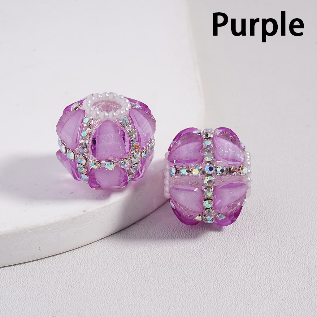 Purple beaded charm with crystal accents on a light gray background