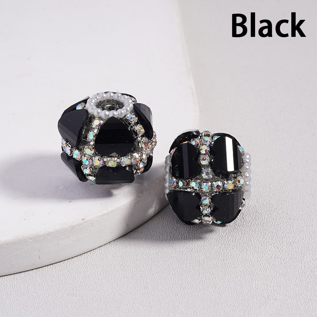 Black earrings with gemstones on a white background