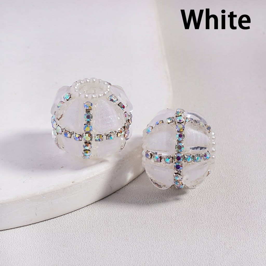 Pair of earrings with rhinestone detailing on a white surface