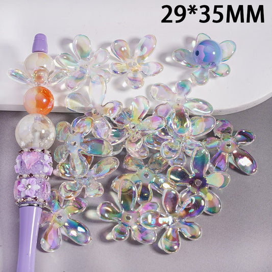 Iridescent flower-shaped beads with a purple handle on a gray background