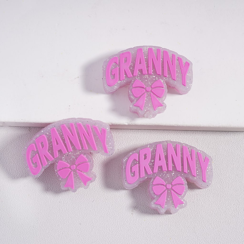 Pink 'GRANNY' earrings with bows on a white background