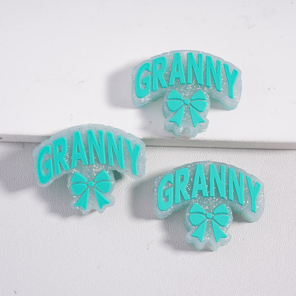 Three decorative items with 'GRANNY' text and bow designs on a white background