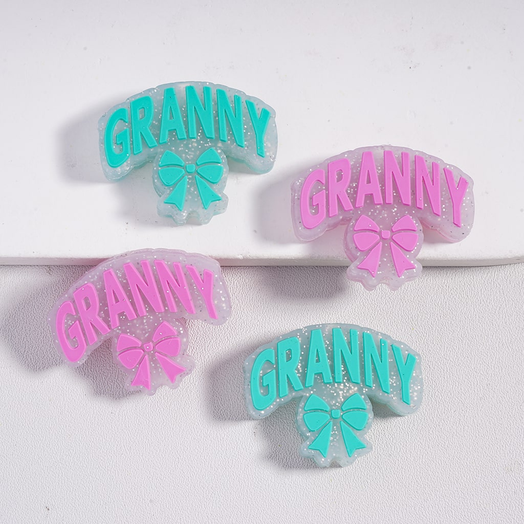 Four decorative hair clips with 'GRANNY' text and bow designs on a white background.