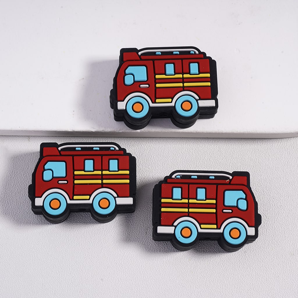 Three fire truck-shaped rubber stamps on a white background