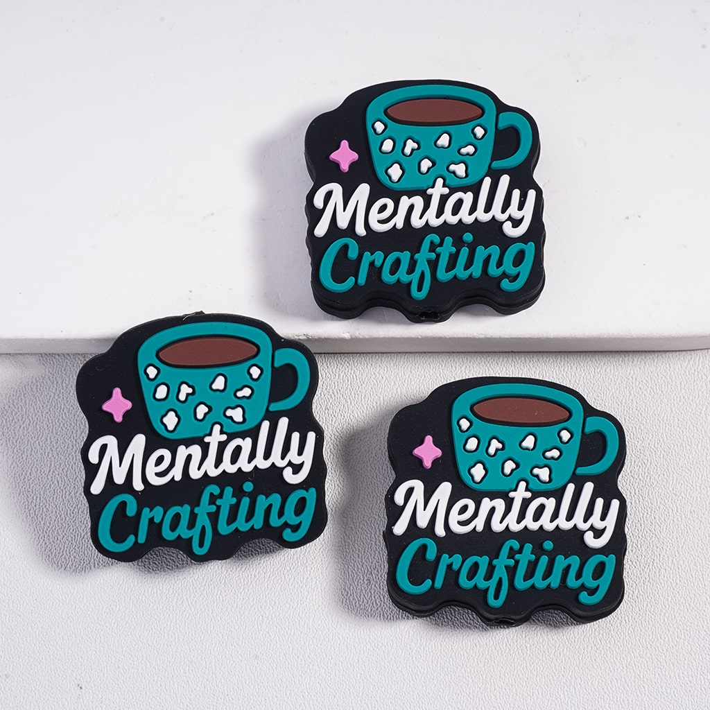 Three 'Mentally Crafting' coasters with teal mugs on a white background