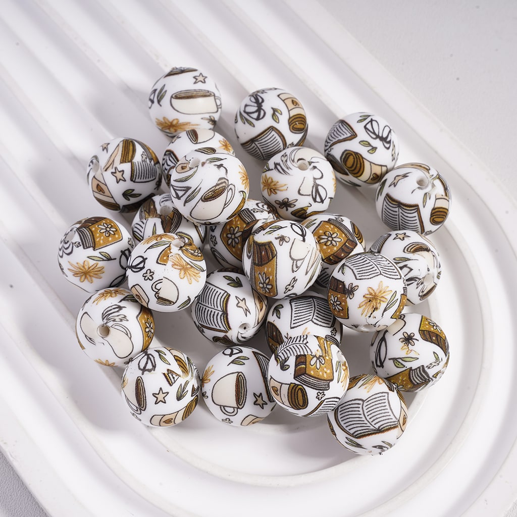 Decorative beads with intricate patterns on a white surface