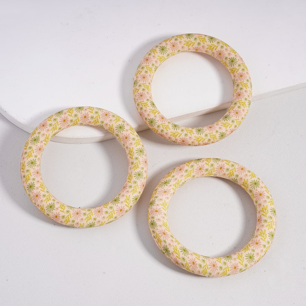 Three floral-patterned bangles on a white background