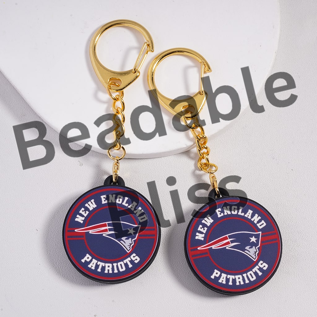 New England Patriots keychains with gold hooks on a white background