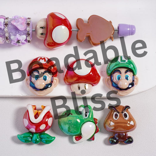 Set of colorful character beads on a white background with 'beadablebliss' branding.