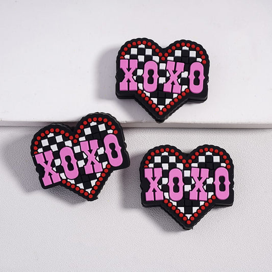 Heart-shaped earrings with 'XOXO' text on a white background