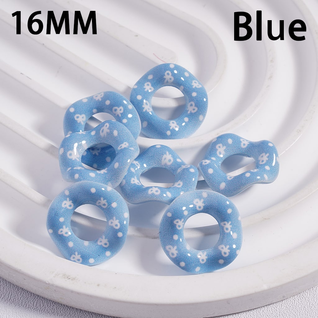 Blue rubber bands with white polka dots on a white circular tray