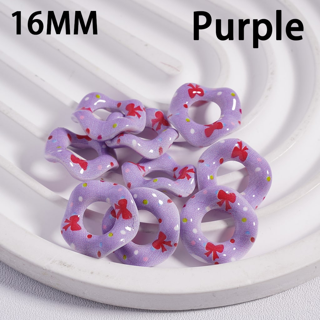 Purple hair ties with red bows on a white plate