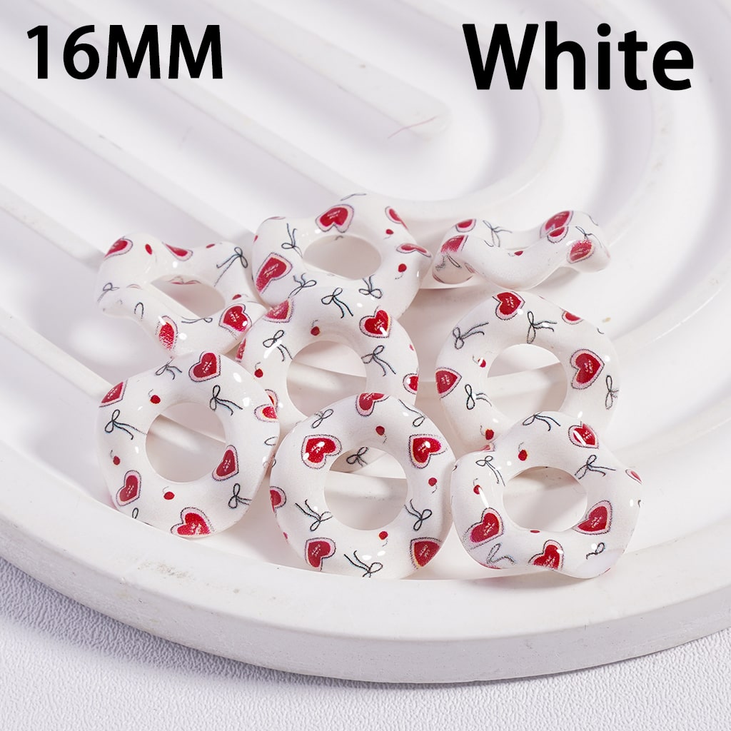 White hair scrunchies with red heart patterns on a white background