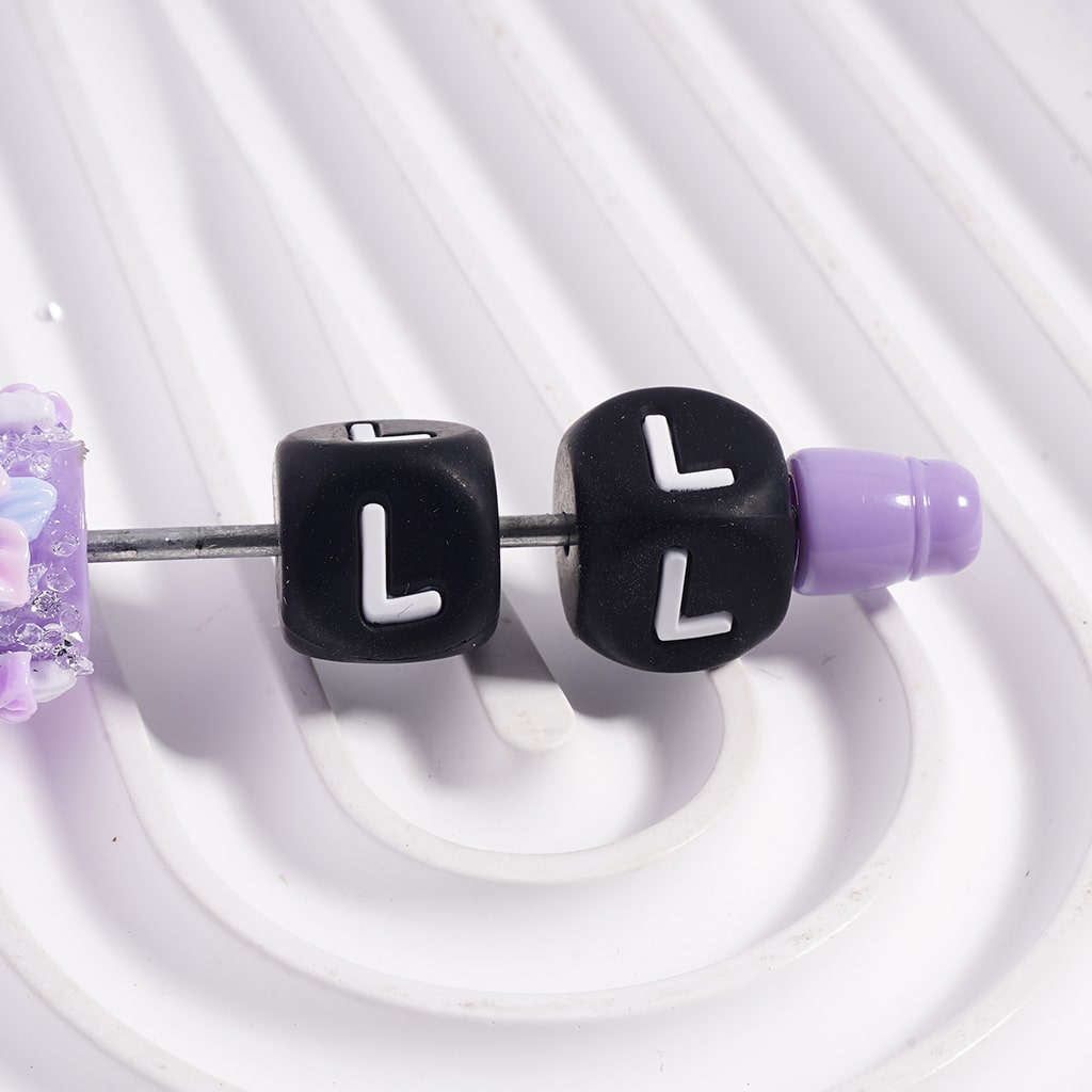 Close-up of earbud tips with 'LL' lettering on a white background