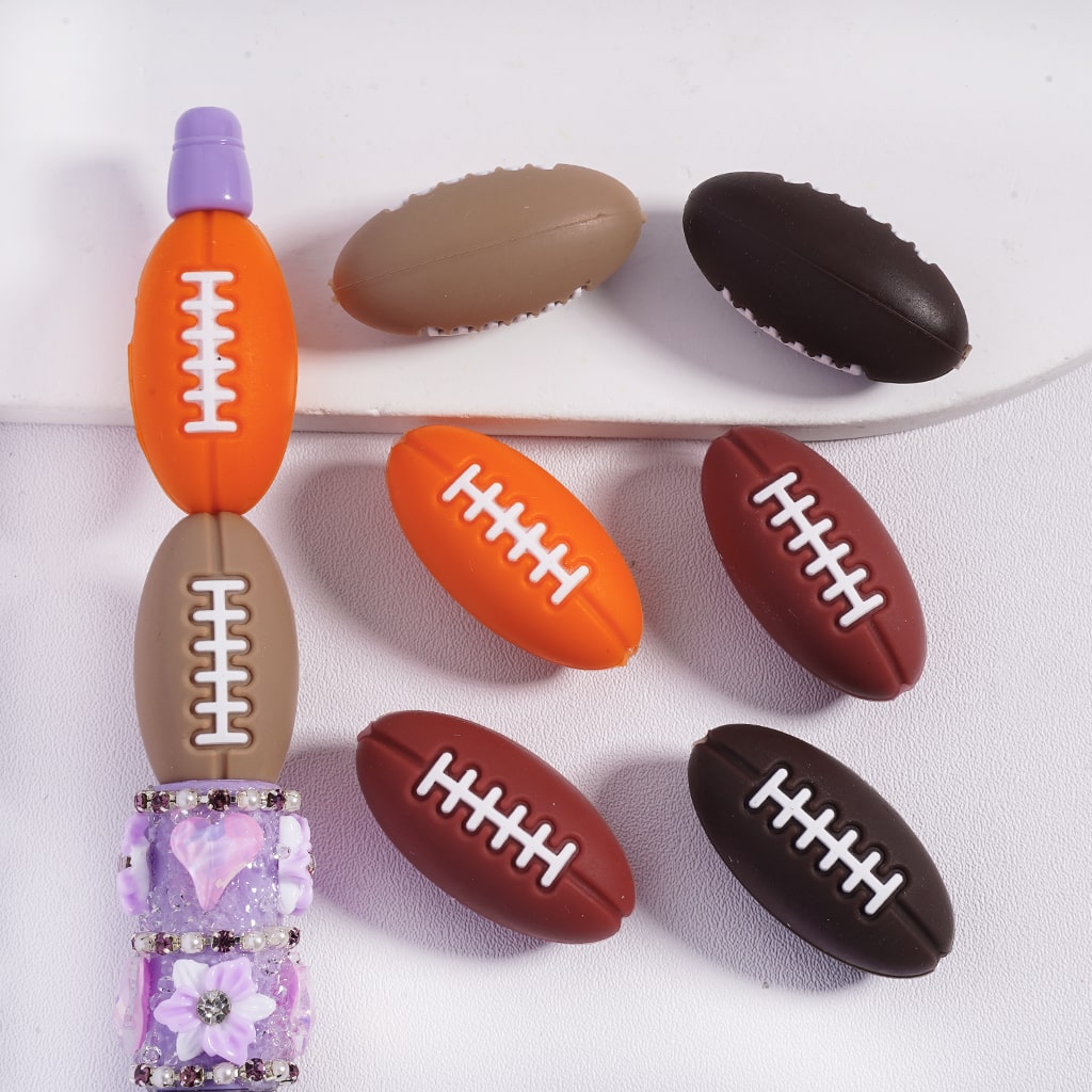 Set of colorful football-shaped erasers on a white background