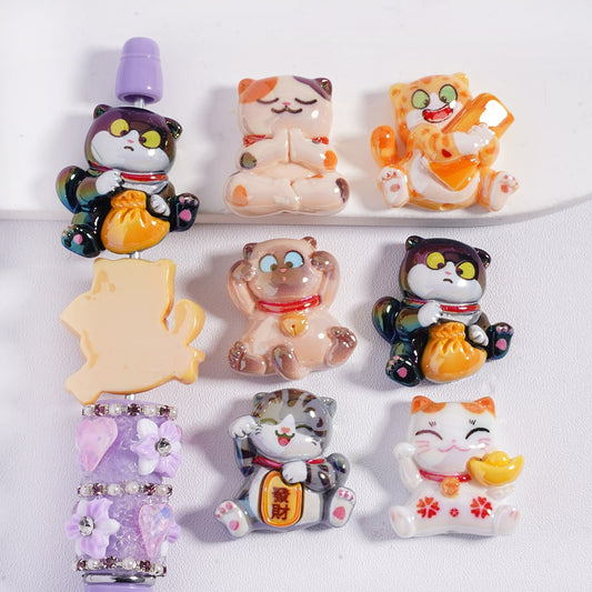 Set of colorful cat-shaped figurines on a white background