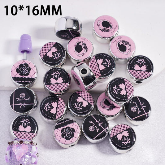 Decorative beads with pink and black designs on a white background