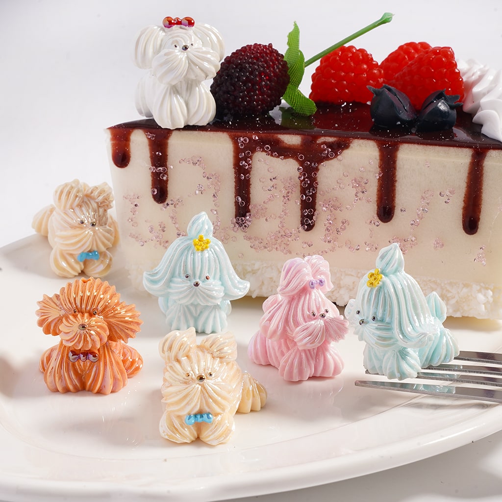 Small dog-shaped desserts on a plate with a cake in the background