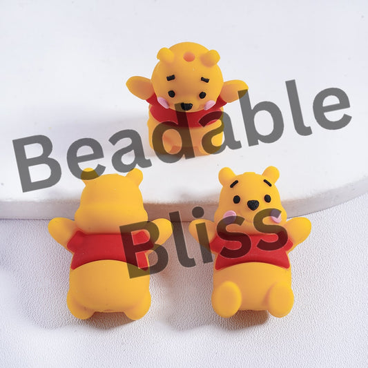 Three yellow bear figurines with red shirts on a white background, branded 'beadablebliss'