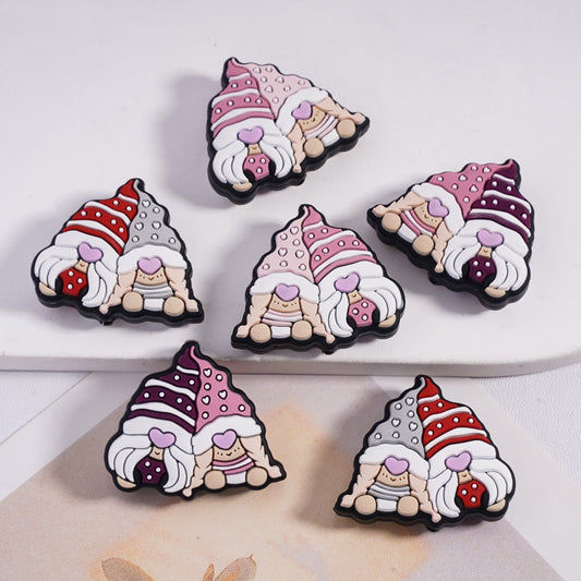 Five cartoon gnome figurines with colorful hats on a white surface.