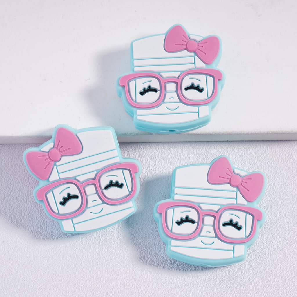 Three cartoon-style paper mummy characters with pink glasses and bows on a light gray background