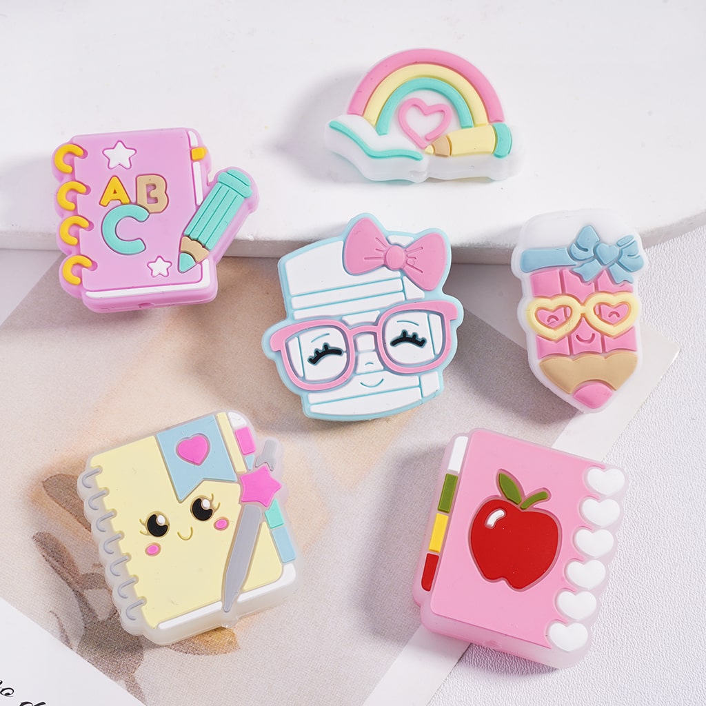 Set of colorful children's erasers with various designs on a white background