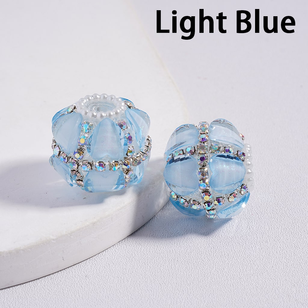 Light blue earrings with crystal accents on a white background