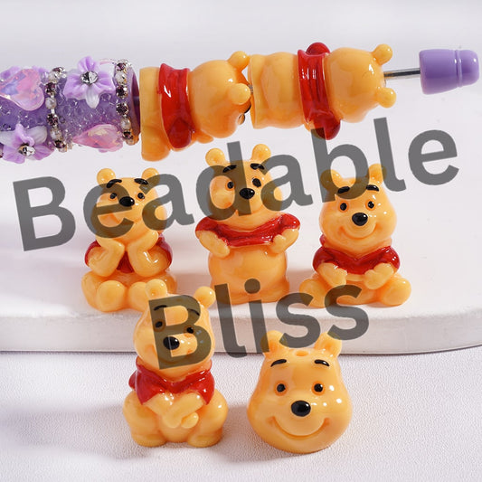 Set of Winnie the Pooh-themed beads and charms on a white background with 'beadablebliss' branding.