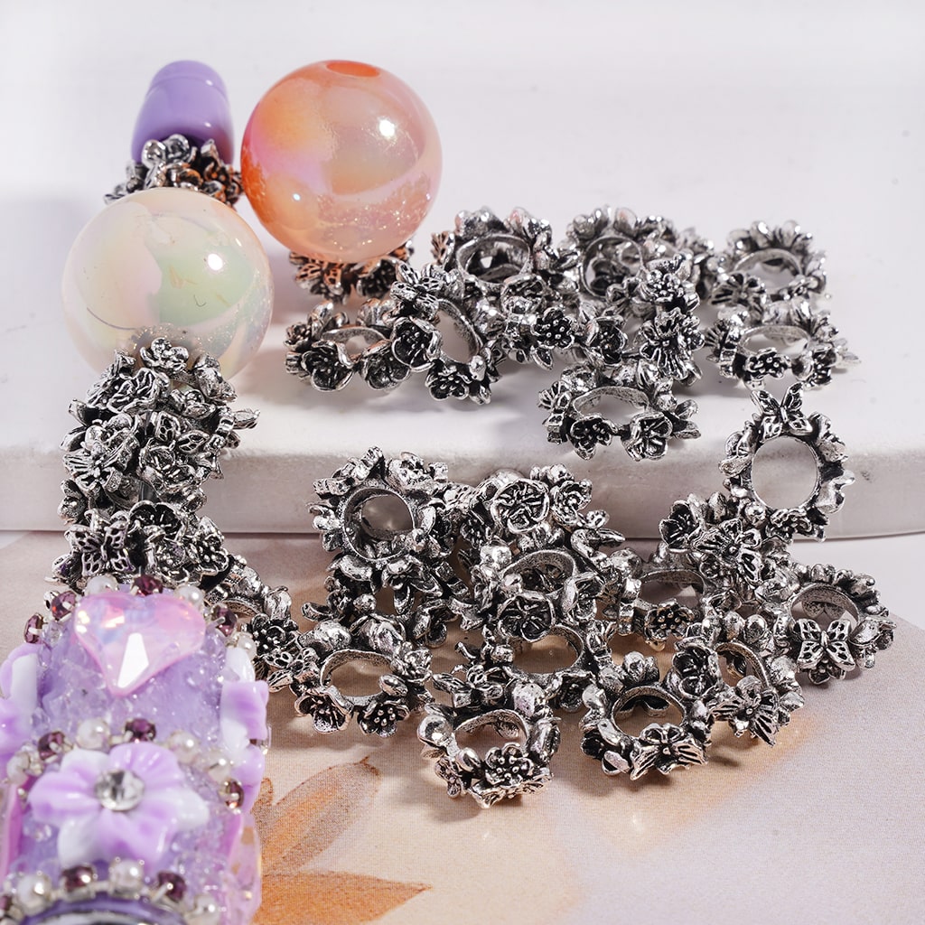 Silver floral bracelet with colorful beads on a white background