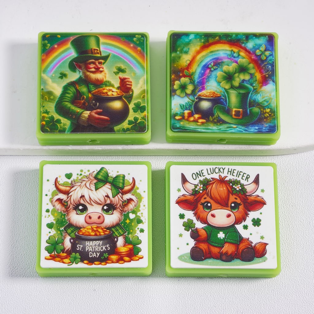 Four St. Patrick's Day-themed coasters with leprechaun, rainbow, pot of gold, and cows on a white background.