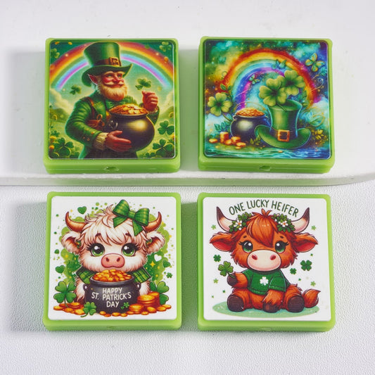 Four St. Patrick's Day-themed coasters with leprechaun, rainbow, pot of gold, and cows on a white background.