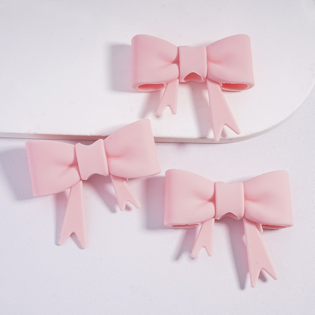 Three pink bows on a white background