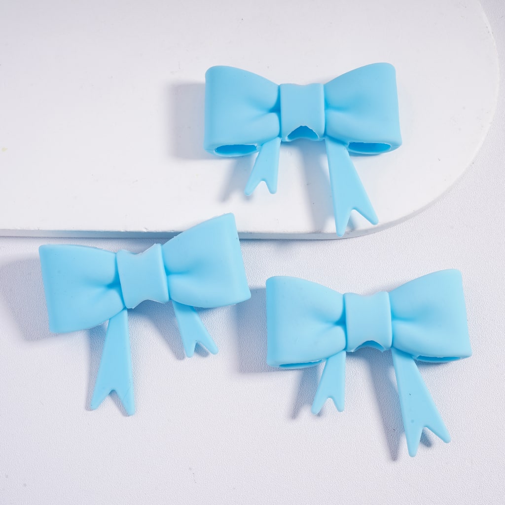 Three light blue hair bows on a white background