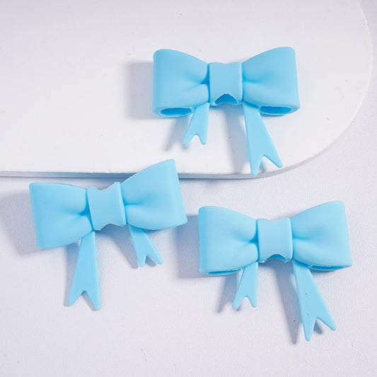 Three light blue hair bows on a white background